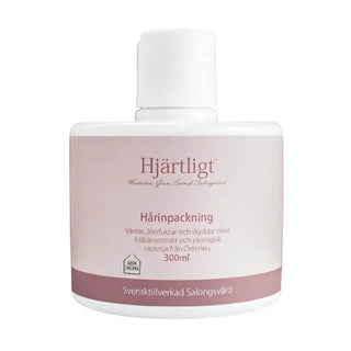 Vit och rosa plastflaska med hårbehandling.